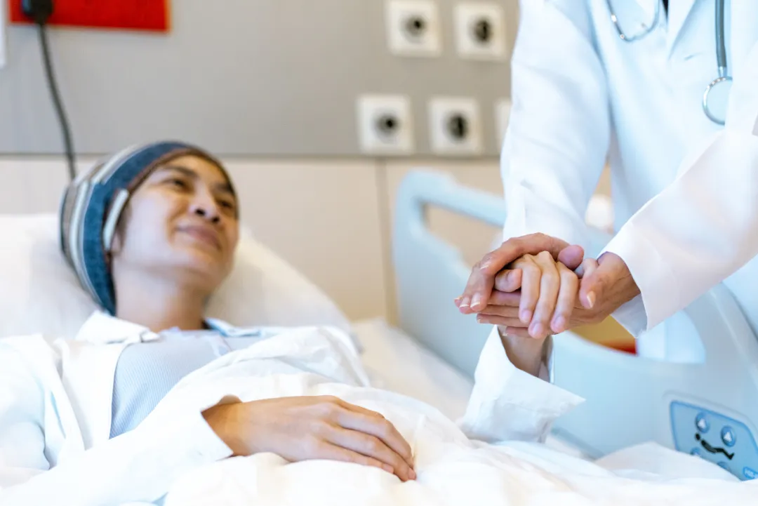 Oncologist holding a chemotherapy patient's hand at United Family Healthcare
