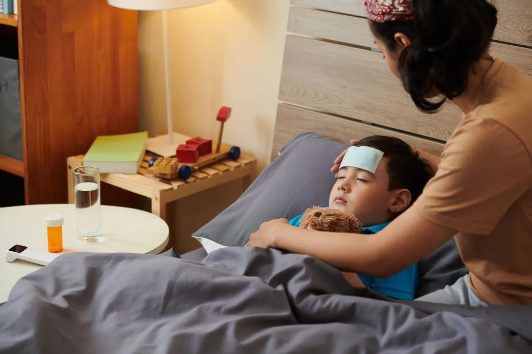 Child with fever being cared for at home